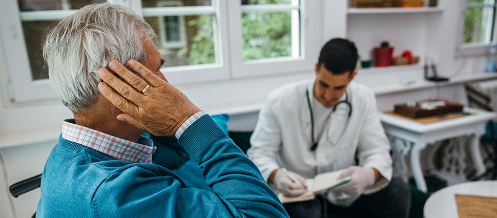 Doctor talks with a patient who complains of earache
